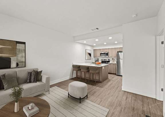 a bedroom with a door and hardwood floors