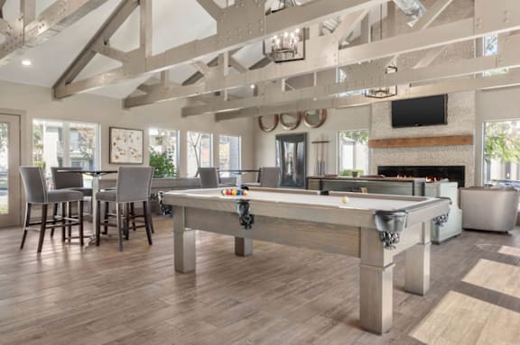 a community room with a pool table and a bar at South Lamar Village, TX, 78704