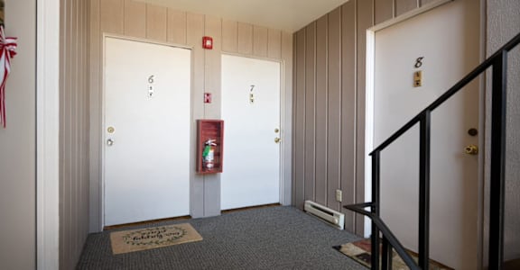 a view of the hallway from the top of the stairs