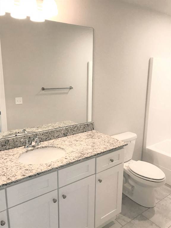 B3 (1-car) Master Bath with granite countertops, sink, toilet, and shower