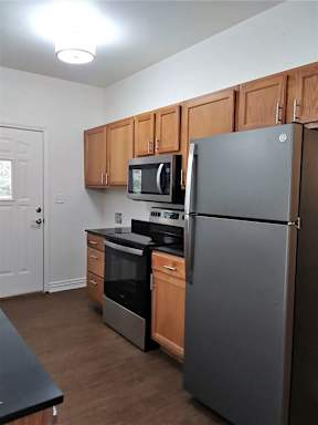 A kitchen with a refrigerator at 55 and better apartment community