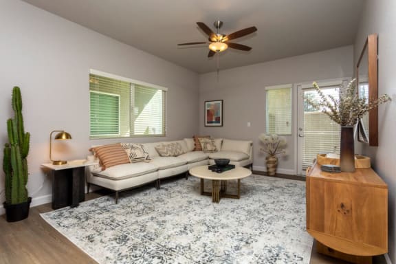 a living room with a couch and a ceiling fan
