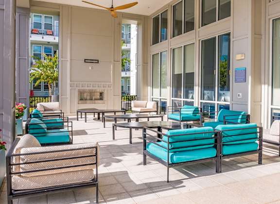 Patio with blue chairs at Linden on the GreeneWay, Orlando, FL, 32824