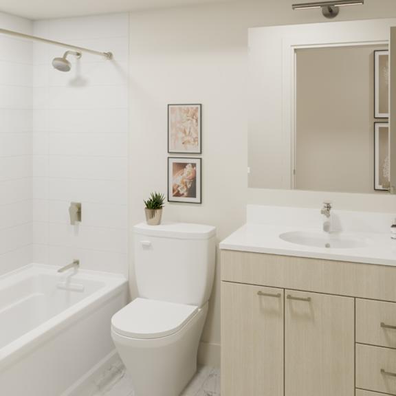 A white toilet sits next to a white sink in a bathroom.