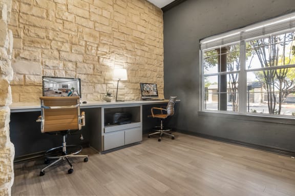 an office with a brick wall and wood flooring  at Rogers Ranch, Texas