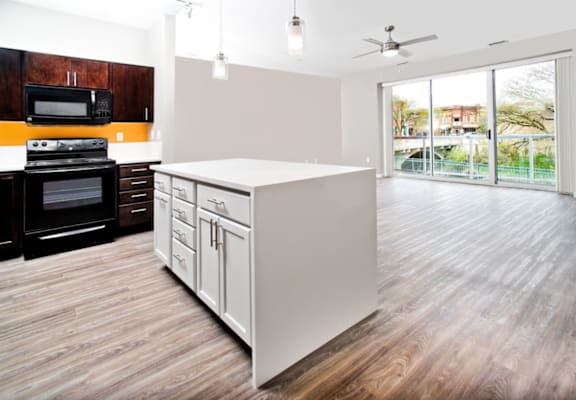 a kitchen with a large island in the middle of a living room