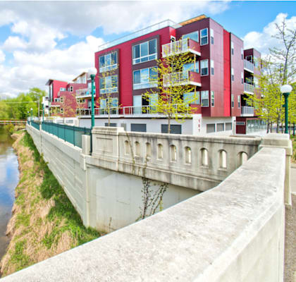 a bridge over a river with buildings on the side of it