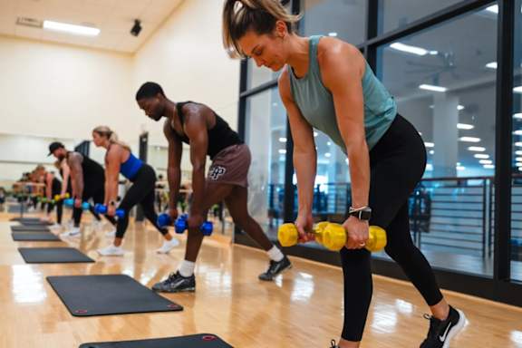 A group of people exercising in a gym.