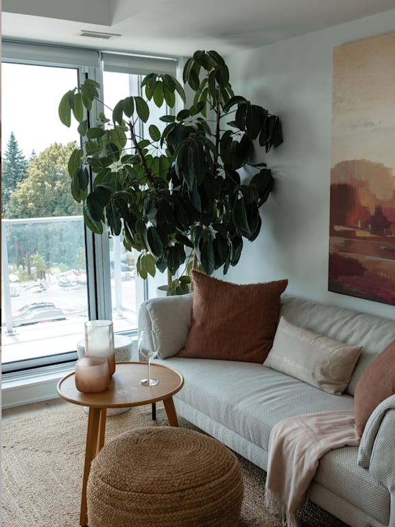 A dining room with a table and chairs and a painting on the wall.at Baseline Apartments, Ottawa, ON
