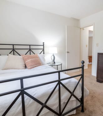 a bedroom with a bed and a lamp and a mirror