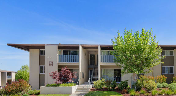 an apartment building with a street in front of it