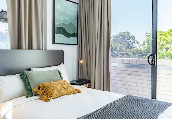 a bedroom with a bed and a window
