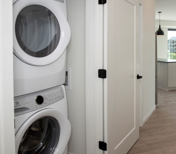 Laundry Center with Machines Next to Folding Counter at The Hill Apartments, Saint Paul, Minnesota
