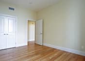 Thumbnail 3 of 23 - A room with a white door and a white cabinet.