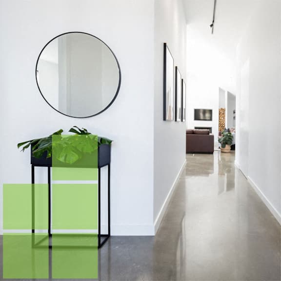 a round mirror hanging above a green table with a plant on it at Anthem at Square 10 in New Haven, CT 06511