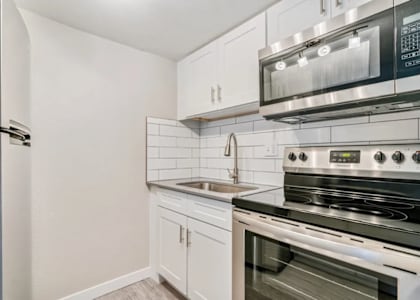 A kitchen with a stainless steel oven and microwave above it. at Tides on East Cactus Apartments, Phoenix, AZ