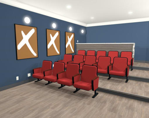 a large empty theater room with red chairs
