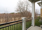 Thumbnail 13 of 31 - A balcony with a black railing and a white column.