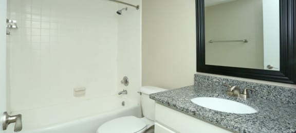 Renovated bathroom with granite countertops and new vanity