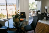 A living room with a glass table and chairs. at Three Crown Apartments, California, 94501