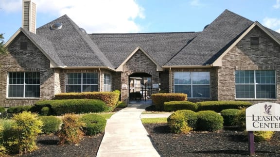 a house with a leasing center sign in front of it
