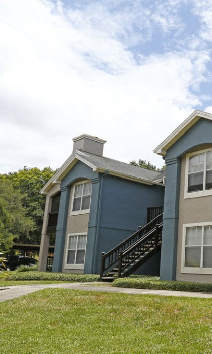 a building with a lawn and a sidewalk in front of it