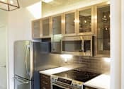 Thumbnail 9 of 23 - A kitchen with a stainless steel refrigerator and microwave ovens.