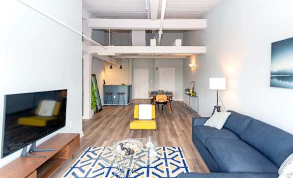 a living room with a blue couch and a tv