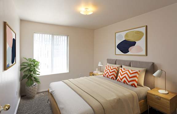 A bedroom with a bed, nightstand, and a painting on the wall.