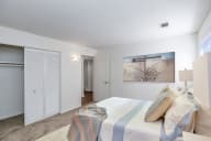 A bedroom with a bed, pillows, and a painting on the wall. at The Bridges at Foxridge, Kansas, 66202