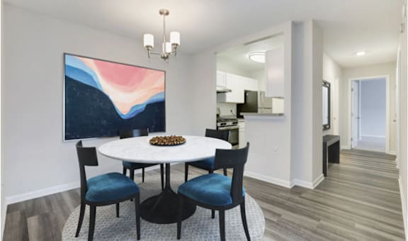 a dining room with a white table and blue chairs