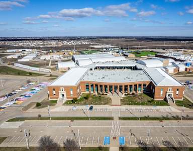 A large building with a parking lot in front of it.