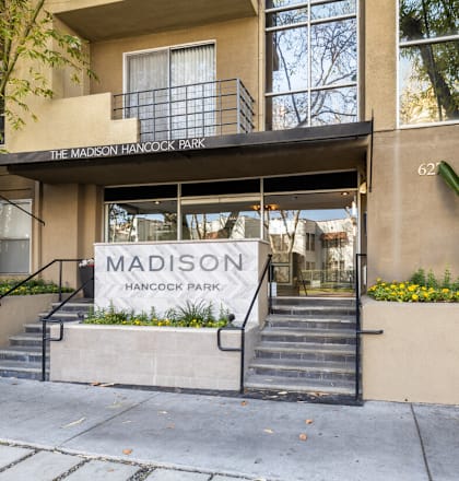 The front of a building with the name "Madison" on it.