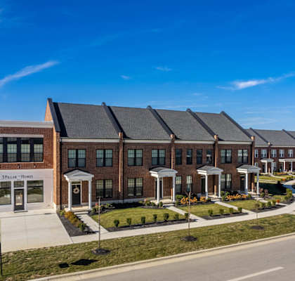 A row of houses with a clear blue sky above them.