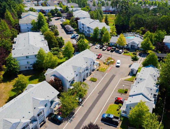 an aerial view of a neighborhood of houses with cars parked