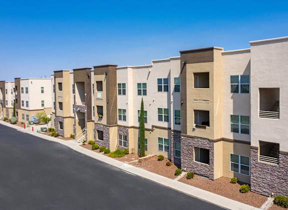 an apartment building with a street in front of it