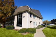 Building with a sidewalk in front of it at Lansing Riverwood, LLC, Lansing, IL