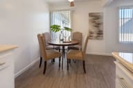 A dining room with a round table and chairs. at Three Crown Apartments, California, 94501
