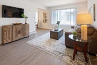 A living room with a wooden floor and furniture. at Three Crown Apartments, California, 94501
