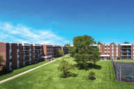 Apartment complex with a green lawn and a playground. at Lansing Riverwood, LLC, Lansing, 60438