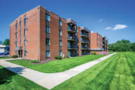 A long brick building with a lawn in front. at Lansing Riverwood, LLC, Lansing, 60438