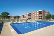 A swimming pool in front of apartment buildings. at Lansing Riverwood, LLC, Lansing, 60438