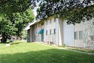 A building with a green lawn in front of it.at Gatehouse Apartments, Kansas City, 64134