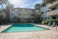 A swimming pool in front of a residential building. at Marine View Apartments, Alameda, CA