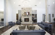 A modern living room with a stone fireplace and a large grey sofa. at The Township, Missouri