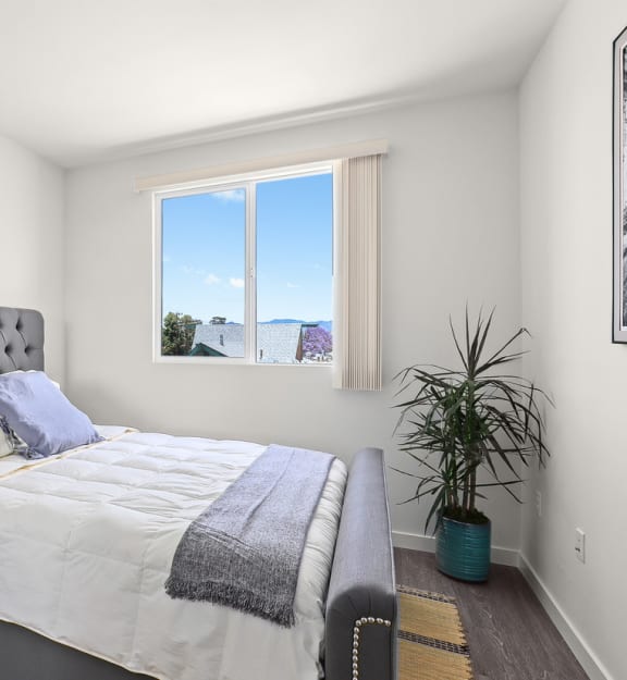 a bedroom with a large bed and a large window