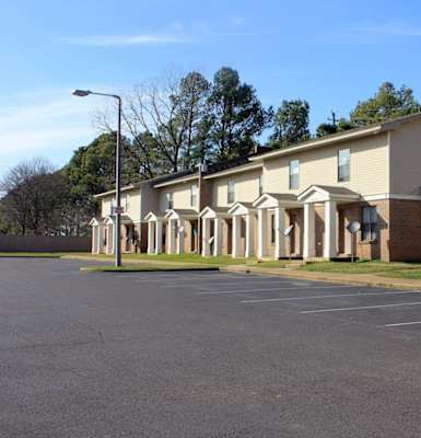 a row of apartment buildings on the side of a road