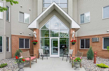 the entrance to a building with glass doors and a patio