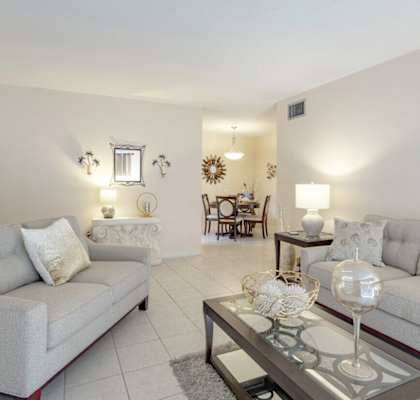 a living room with couches and a glass coffee table
