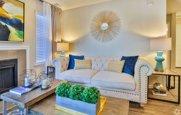 A living room with a white couch and a fireplace. at Magnolia Terrace Apartments, Charlotte, NC, 28213